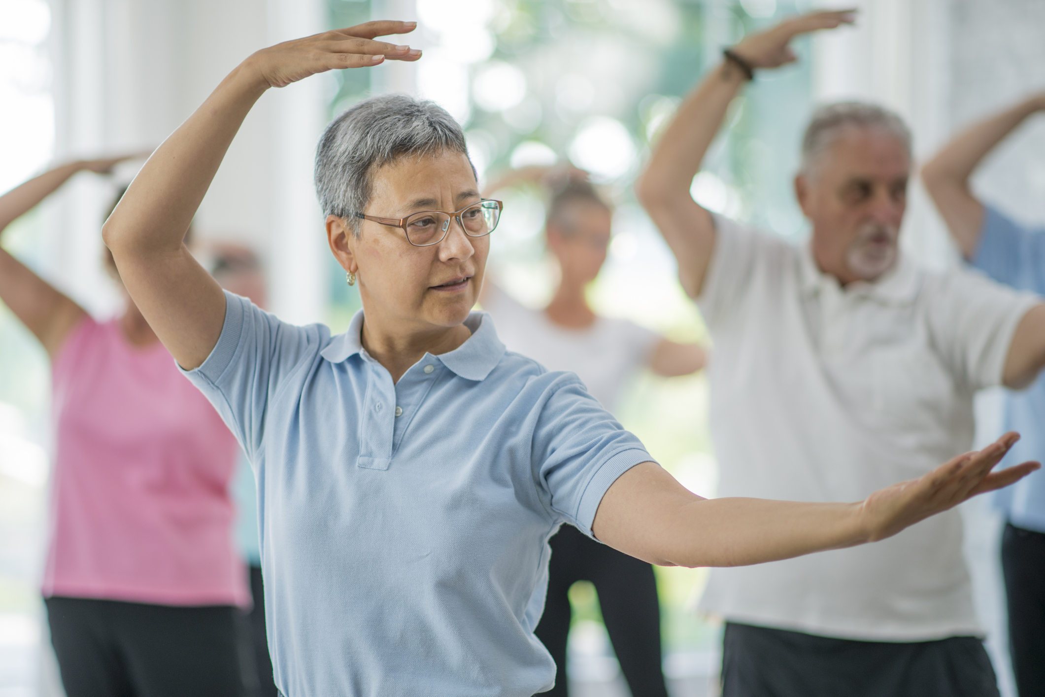 Group of older adults doing Tai Chi