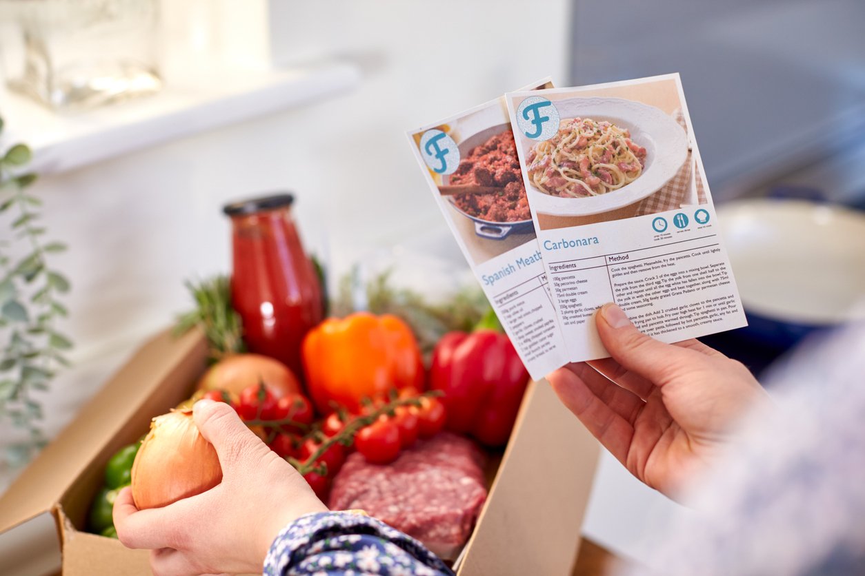 Holding Recipe Cards For Online Meal Food Recipe Kit